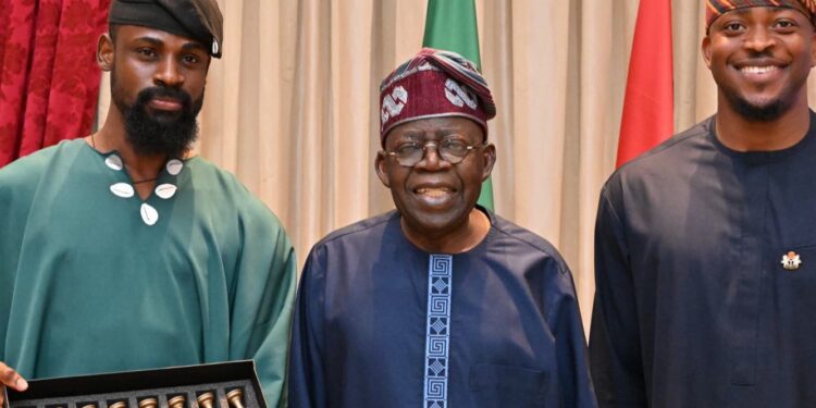 Chess champion Tunde Onakoya presents gold-plated chess to Tinubu